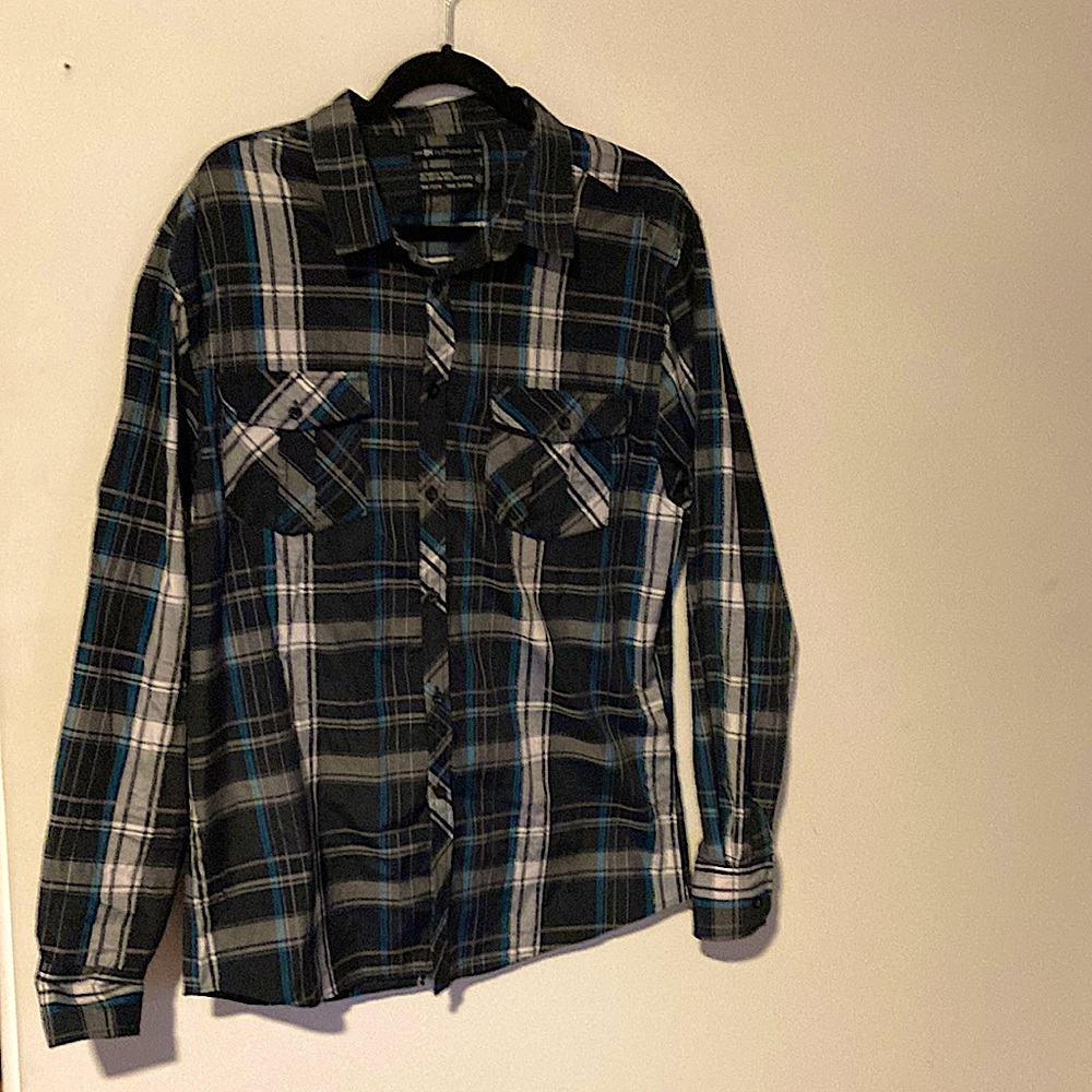 Flannel. Tiny holes on shoulder. Only worn once